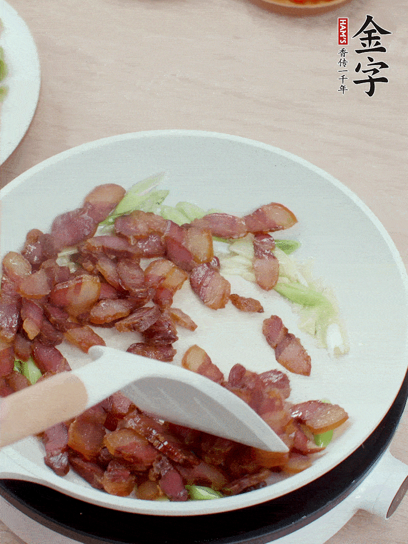 鍋中少許油，姜、蒜白爆香，下臘肉煸出油脂。