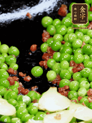 鍋內(nèi)少許油，下火腿煸香，再下甜豆米、百合翻炒，少許鹽、一點水煮到收干